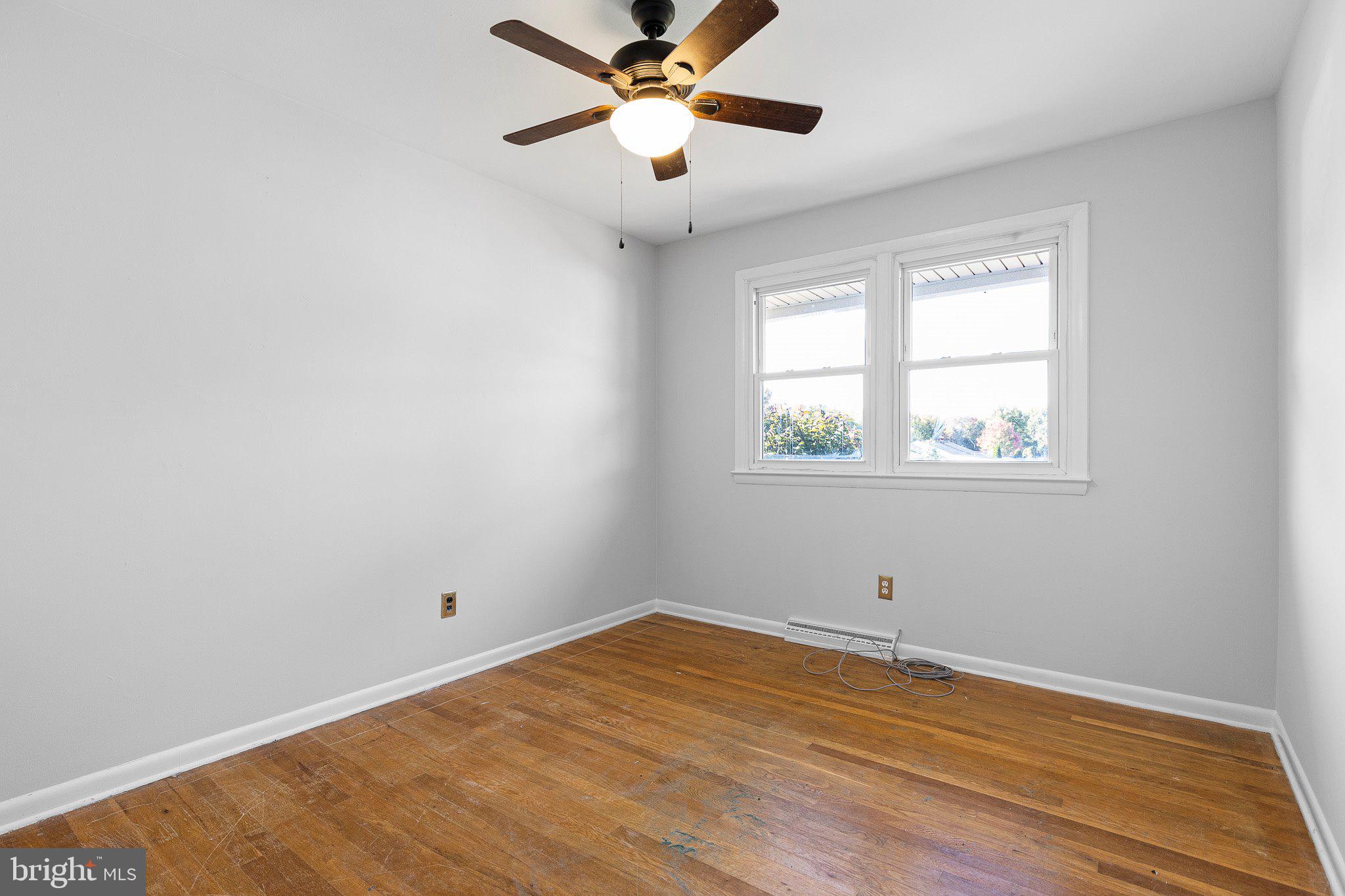 8 Trevett Boulevard Newark, DE 19702 - Photo 13 of 23 a view of an empty room with wooden floor and a window