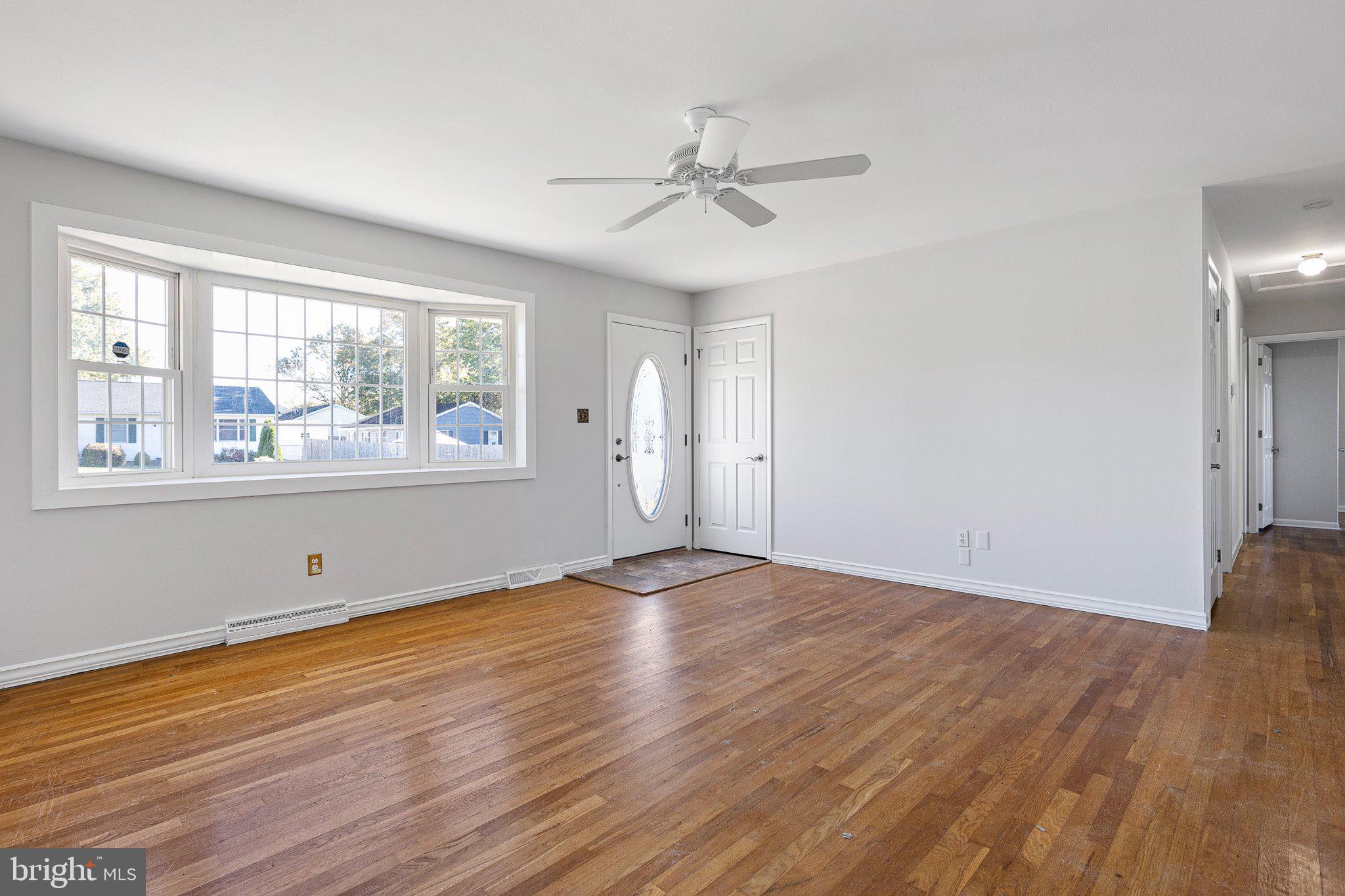 8 Trevett Boulevard Newark, DE 19702 - Photo 3 of 23 a view of empty room with wooden floor and fan
