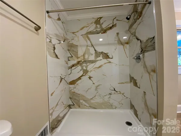 a bathroom with a shower and a toilet