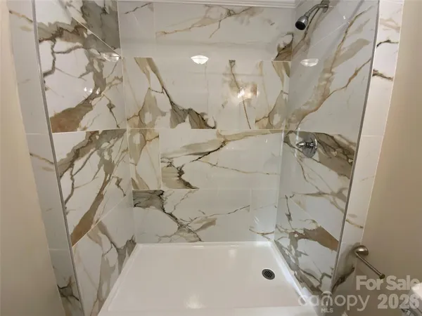 a bathroom with a bathtub and shower