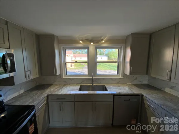 a kitchen with granite countertop a sink and a granite counter tops