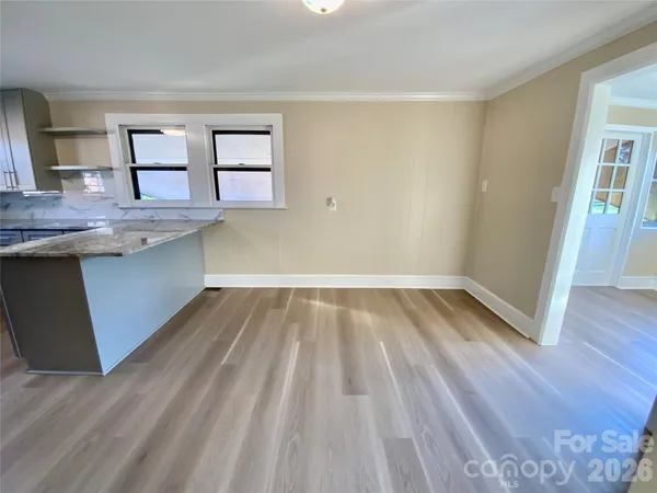a view of kitchen and wooden floor