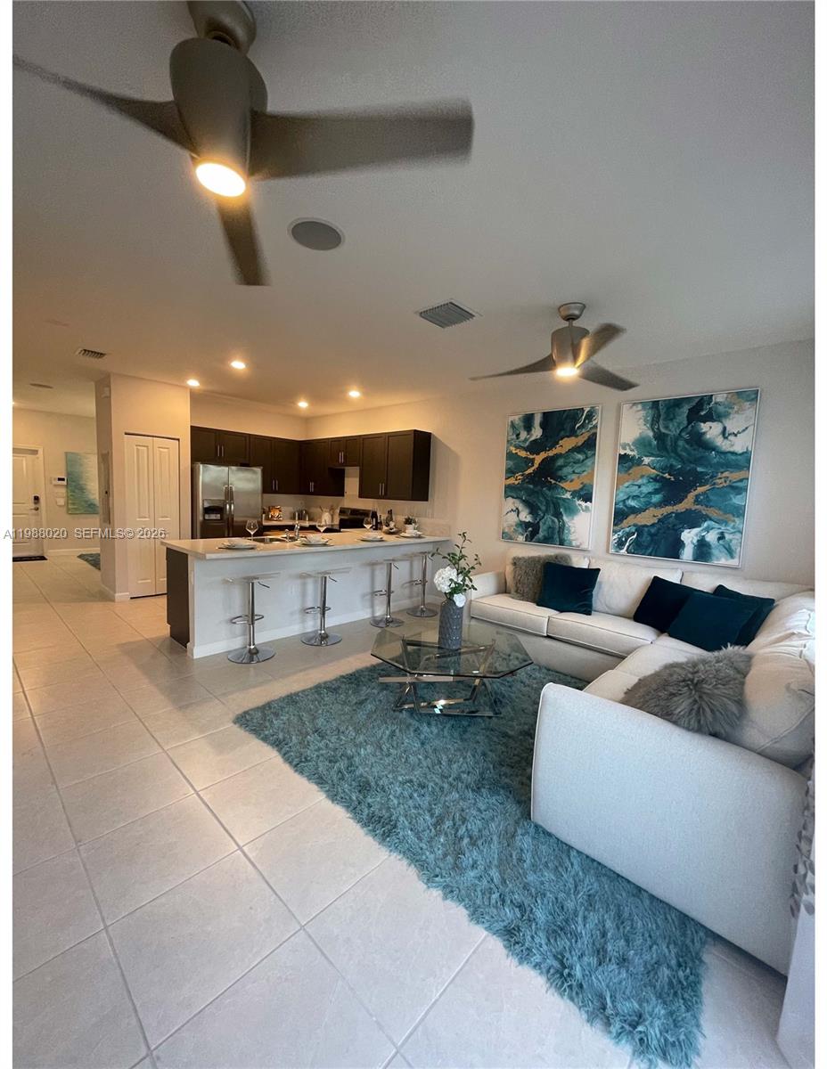 1879 Southeast 27th Street Homestead, FL 33035 - Photo 2 of 10 a living room with couches and kitchen view with wooden floor
