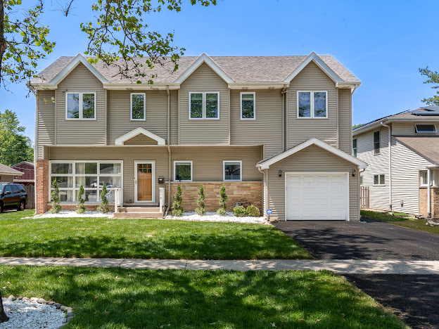 918 Meadow Road Northbrook, IL 60062 - Photo 1 of 38 a front view of a house with a garden and trees