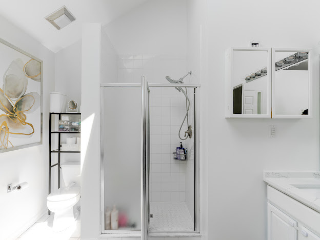 918 Meadow Road Northbrook, IL 60062 - Photo 19 of 38 a bathroom with a shower toilet and sink