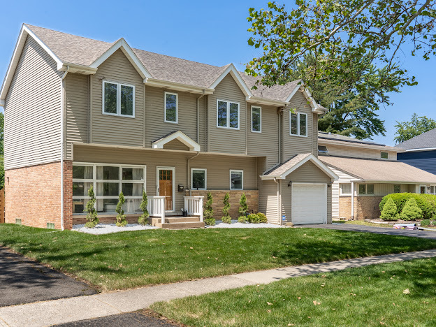 918 Meadow Road Northbrook, IL 60062 - Photo 2 of 38 a front view of a house with a yard and garage