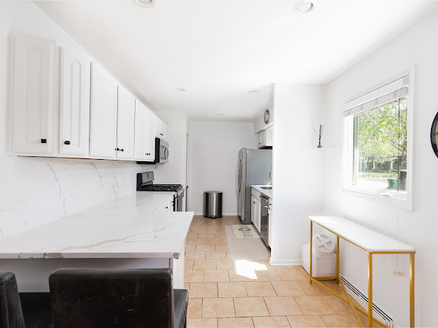 918 Meadow Road Northbrook, IL 60062 - Photo 10 of 38 a kitchen with a white cabinets and window