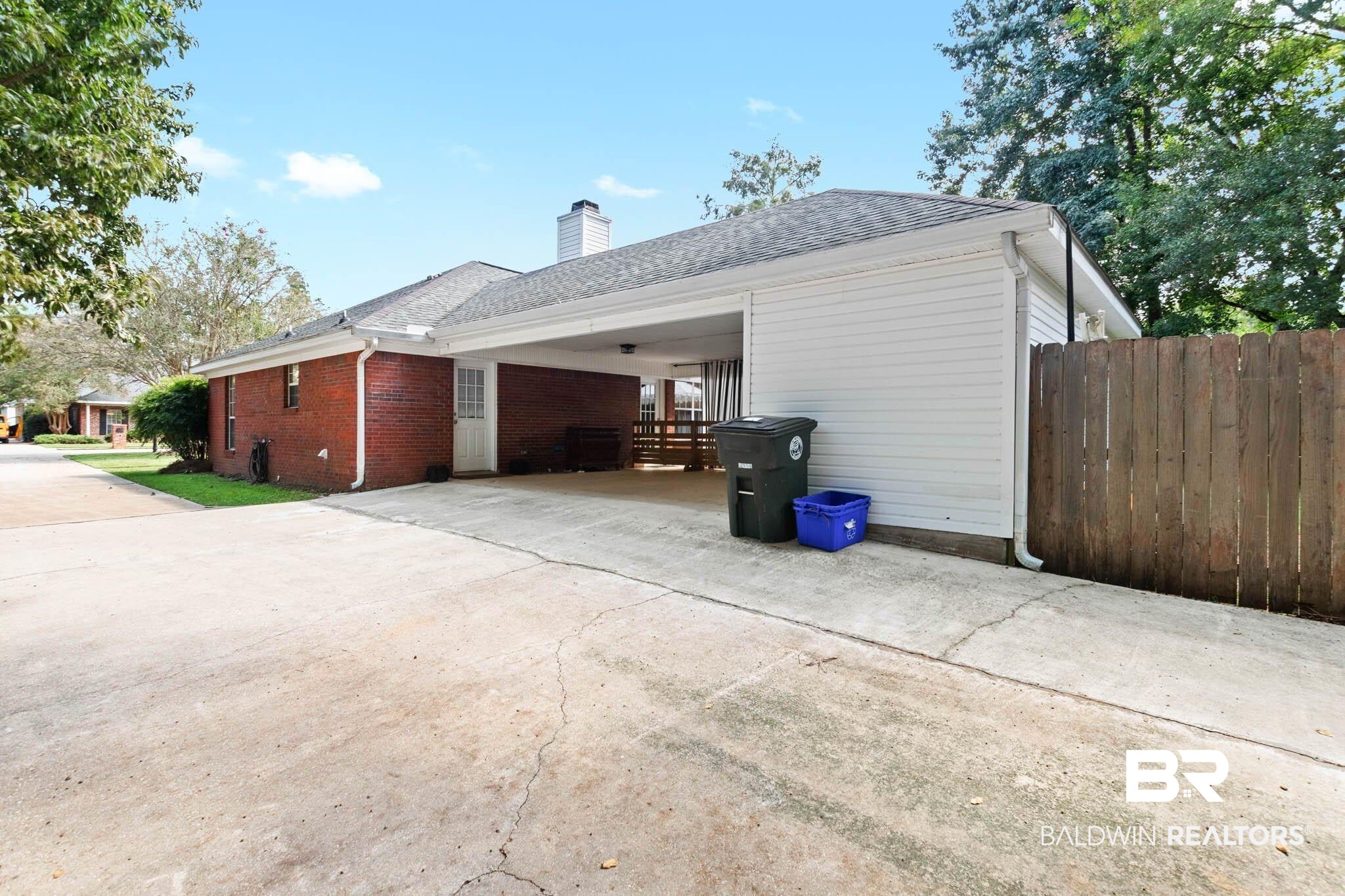 20685 Lowry Drive Fairhope, AL 36532 - Photo 46 of 48 View of side of property with brick siding, driveway, a chimney, and a shingled roof
