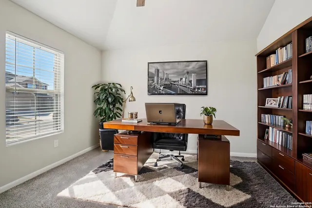 a view of a livingroom with furniture and a potted plant