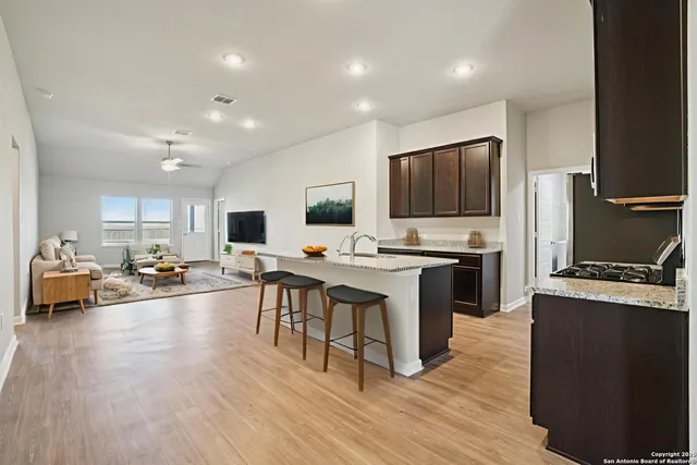 a kitchen with a sink a counter top space stainless steel appliances and cabinets