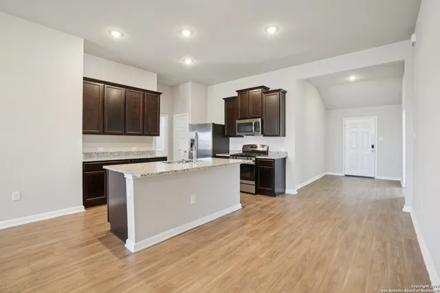 a stove top oven sitting inside of a kitchen