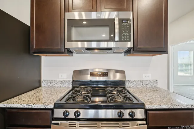 a living room with furniture potted plant and a window