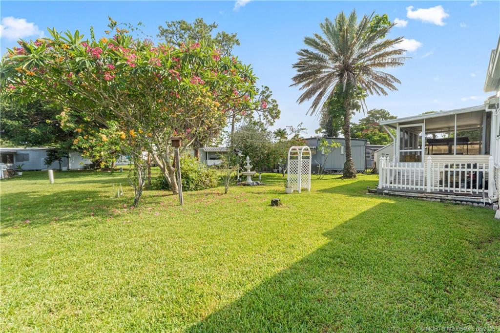 4237 4th Court Lantana, FL 33462 - Photo 33 of 40 a view of a house with a big yard and palm trees