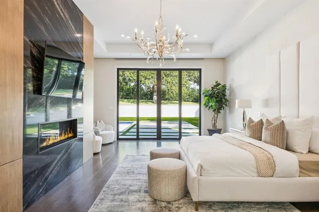 a spacious bedroom with a bed and a large window