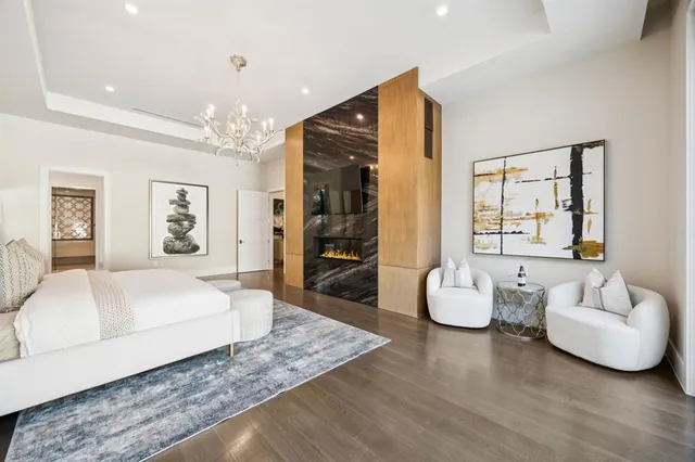 a spacious bedroom with a bed and glass window
