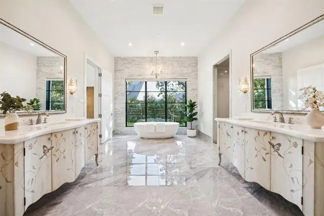 a bathroom with a granite countertop sink mirror and a bathtub