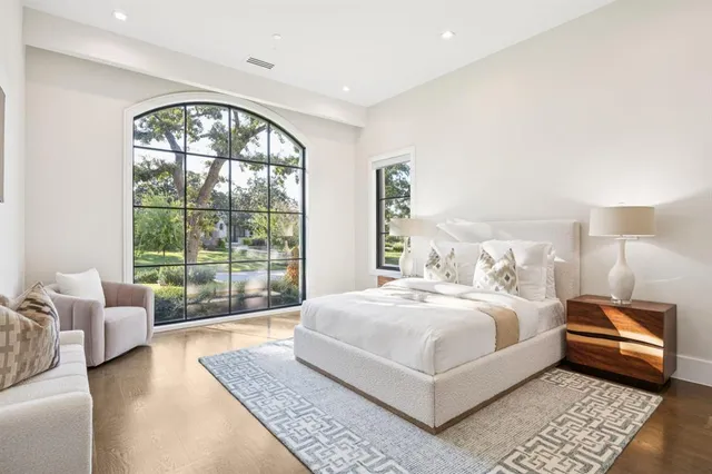 a bedroom with a large bed and a large window