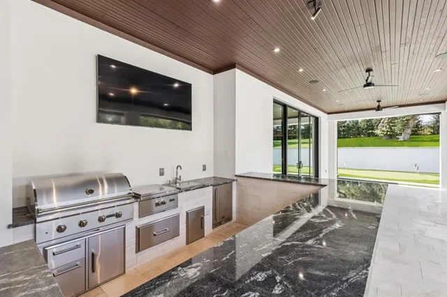a kitchen with stainless steel appliances granite countertop a sink and a stove