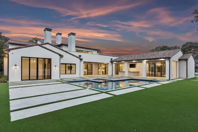 a view of an house with backyard space and balcony