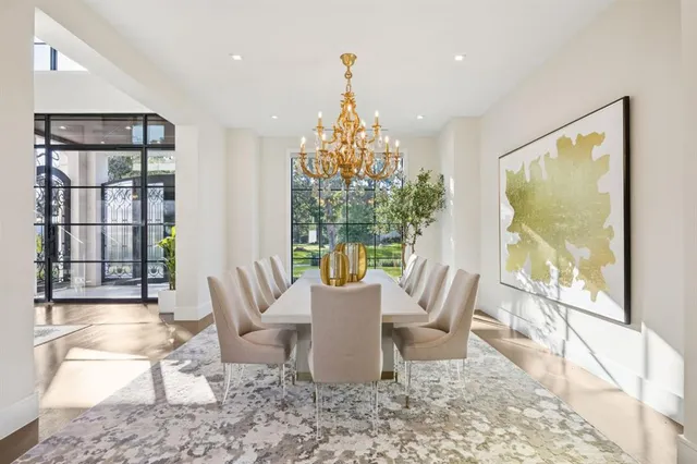 a dining room with furniture a chandelier and wooden floor