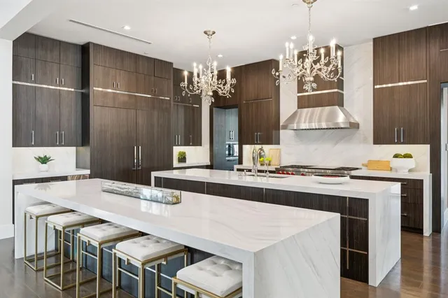 a kitchen with kitchen island granite countertop a sink cabinets and stainless steel appliances