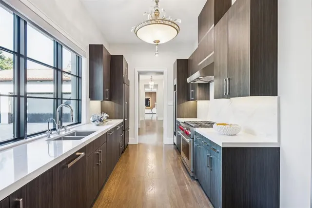 a spacious bathroom with a granite countertop sink a mirror and a bathtub