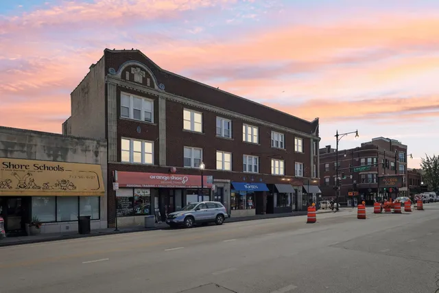 a city street lined with buildings and a cars parked