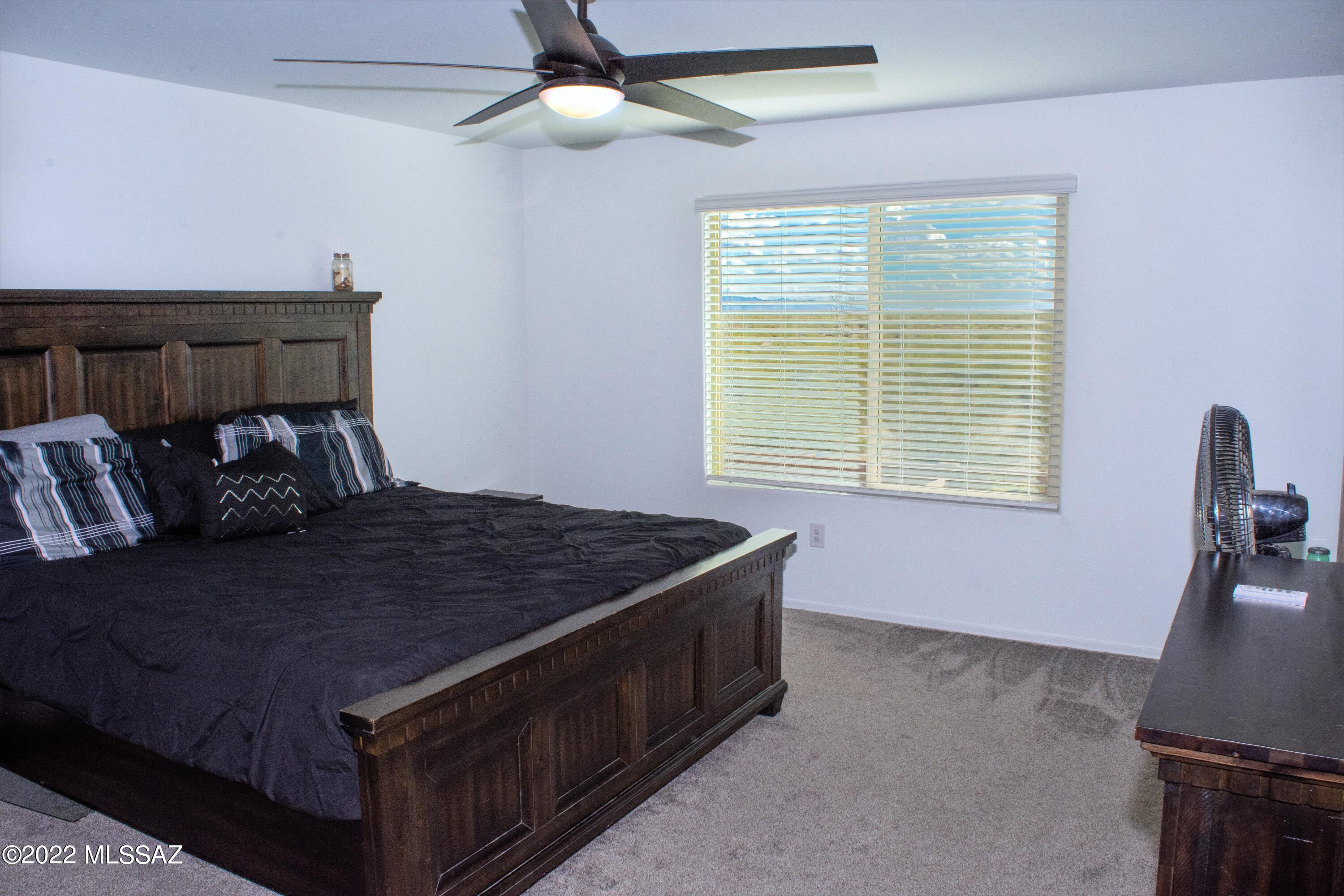 21295 East Treasure Road Red Rock, AZ 85145 - Photo 14 of 34 a bed sitting in a bedroom next to a window