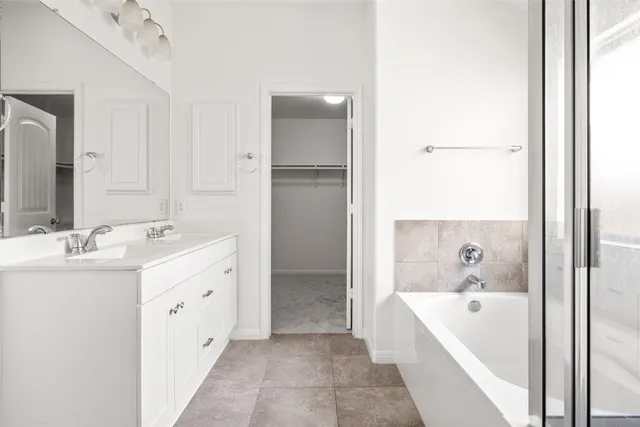 a bathroom with a bathtub and a sink