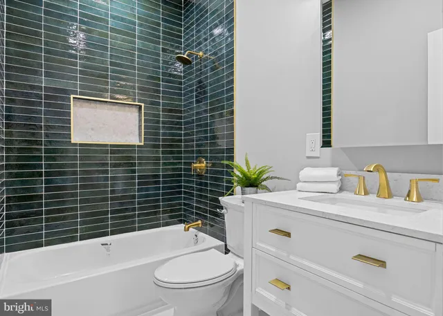 a view of a livingroom with wooden floor and a ceiling fan
