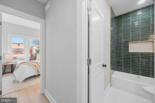 a view of a room with wooden floor and a ceiling fan