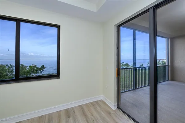 a view of an empty room with wooden floor