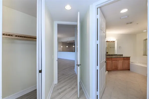 a bathroom with a granite countertop sink mirror and bathtub