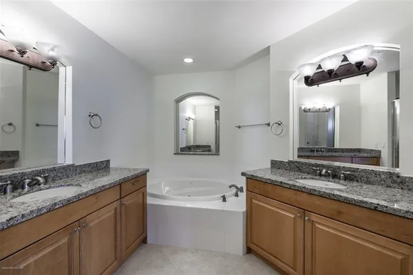 a bathroom with a toilet a sink a tub and mirror