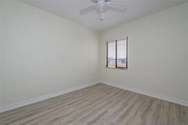 a view of a hallway with wooden floor and closet