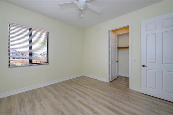 a view of a walk in closet and wooden floor