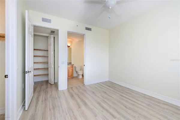 a bathroom with a granite countertop sink and a toilet