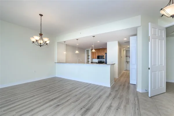 a view of a room with wooden floor pool and windows
