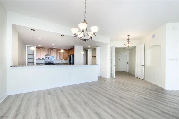 a view of a kitchen with a sink and a chandelier