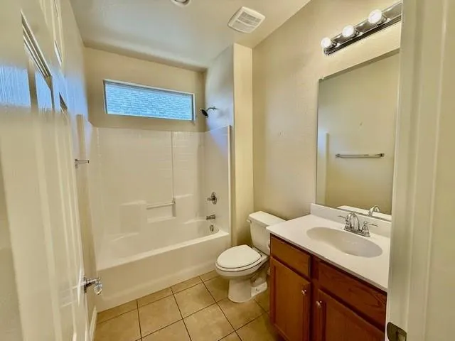 a view of a kitchen with furniture and wooden floor