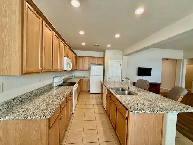 a kitchen with stainless steel appliances granite countertop a sink counter space and cabinets