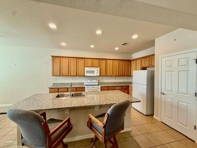 a large kitchen with lots of counter space and windows