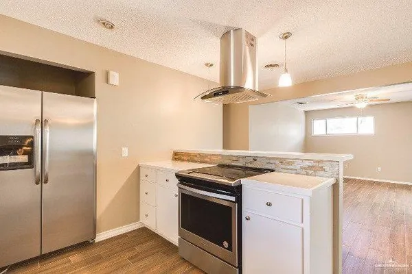 a stove top oven sitting inside of a kitchen