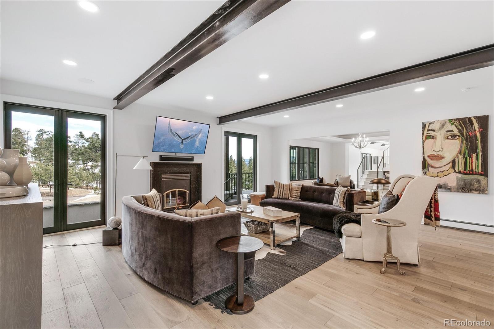1128 County Road 65 Evergreen, CO 80439 - Photo 13 of 40 a living room with fireplace furniture and a large window