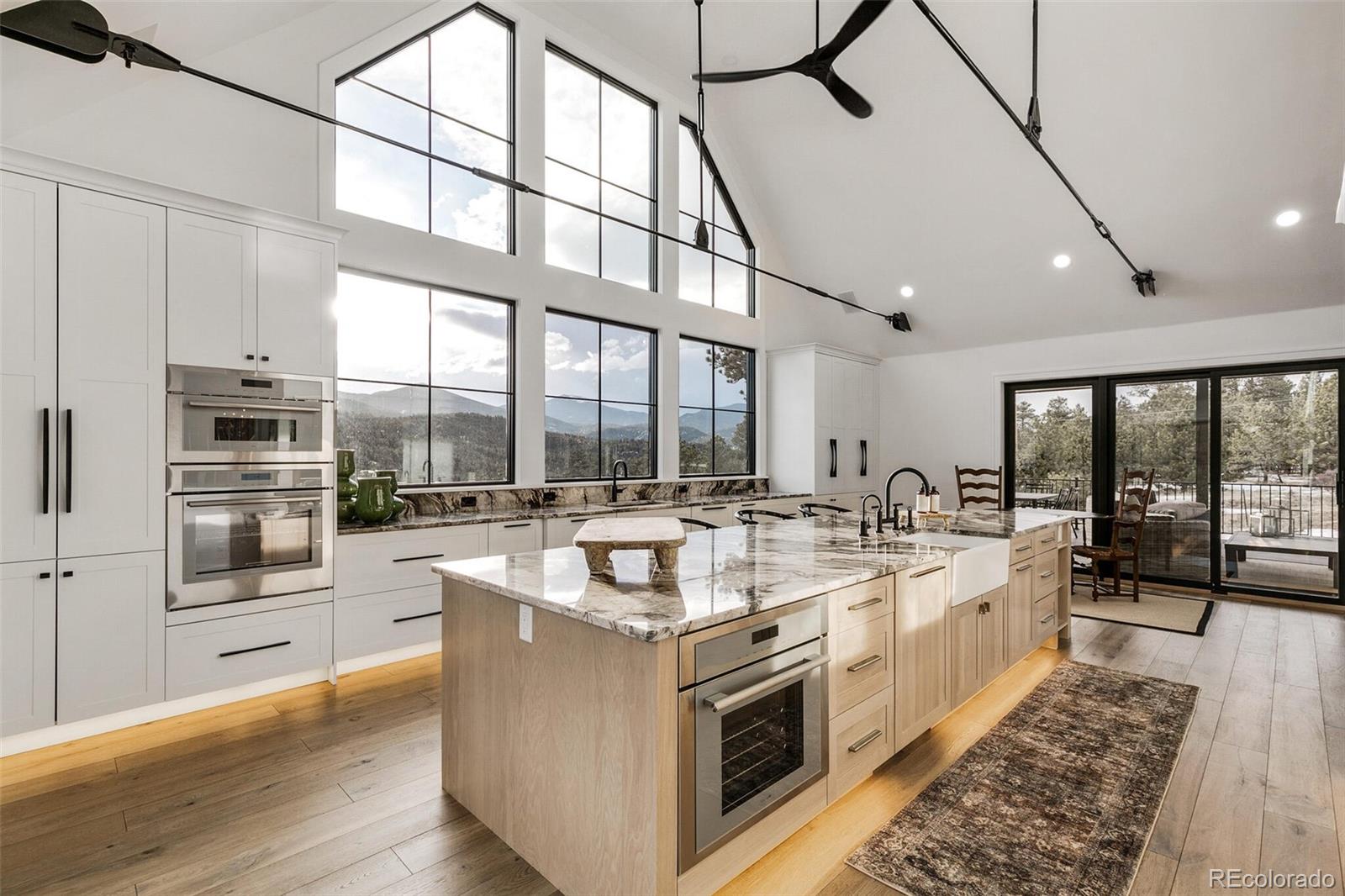 1128 County Road 65 Evergreen, CO 80439 - Photo 2 of 40 a large white kitchen with a large window