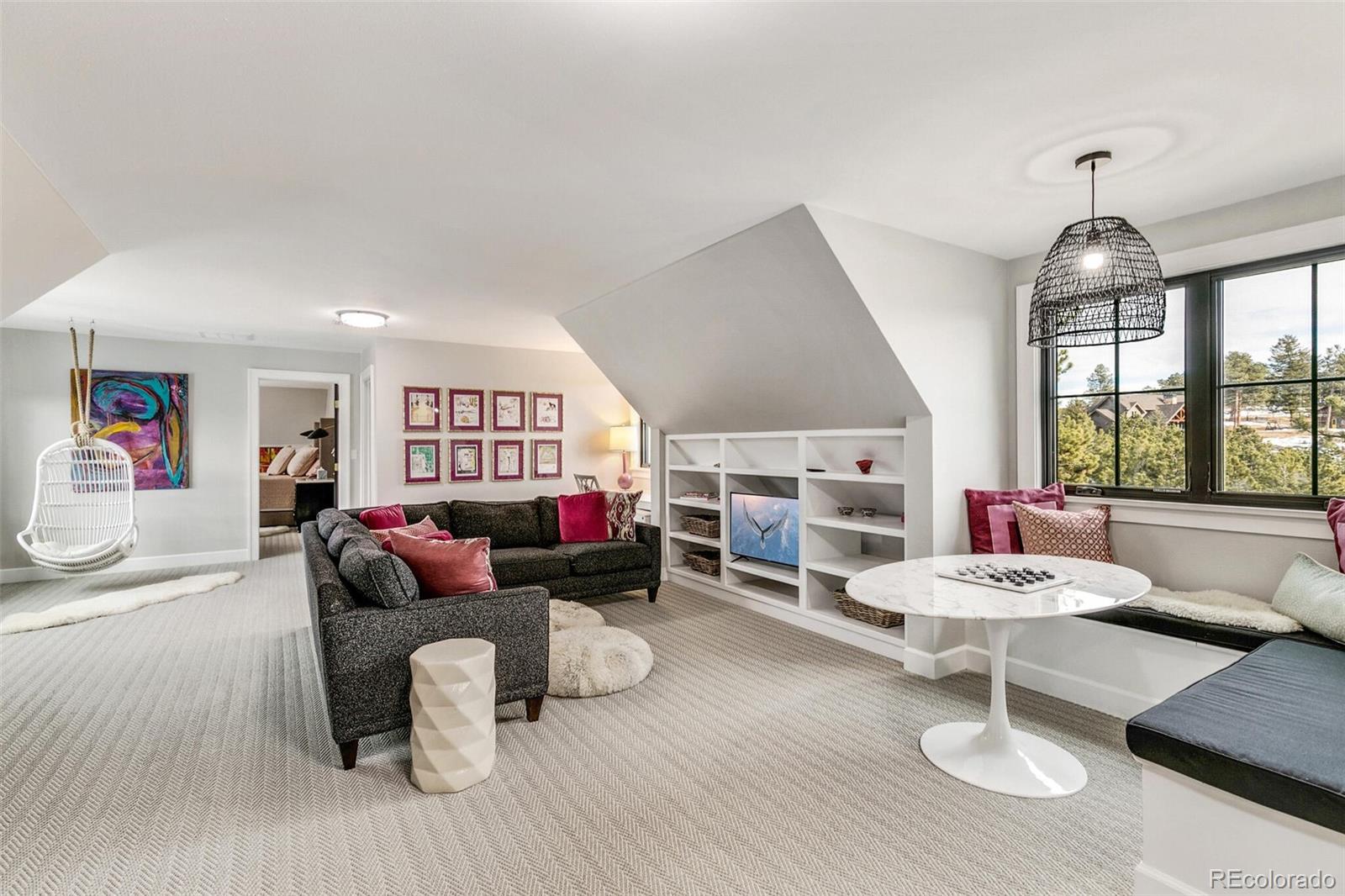 1128 County Road 65 Evergreen, CO 80439 - Photo 21 of 40 a living room with furniture and a wooden floor