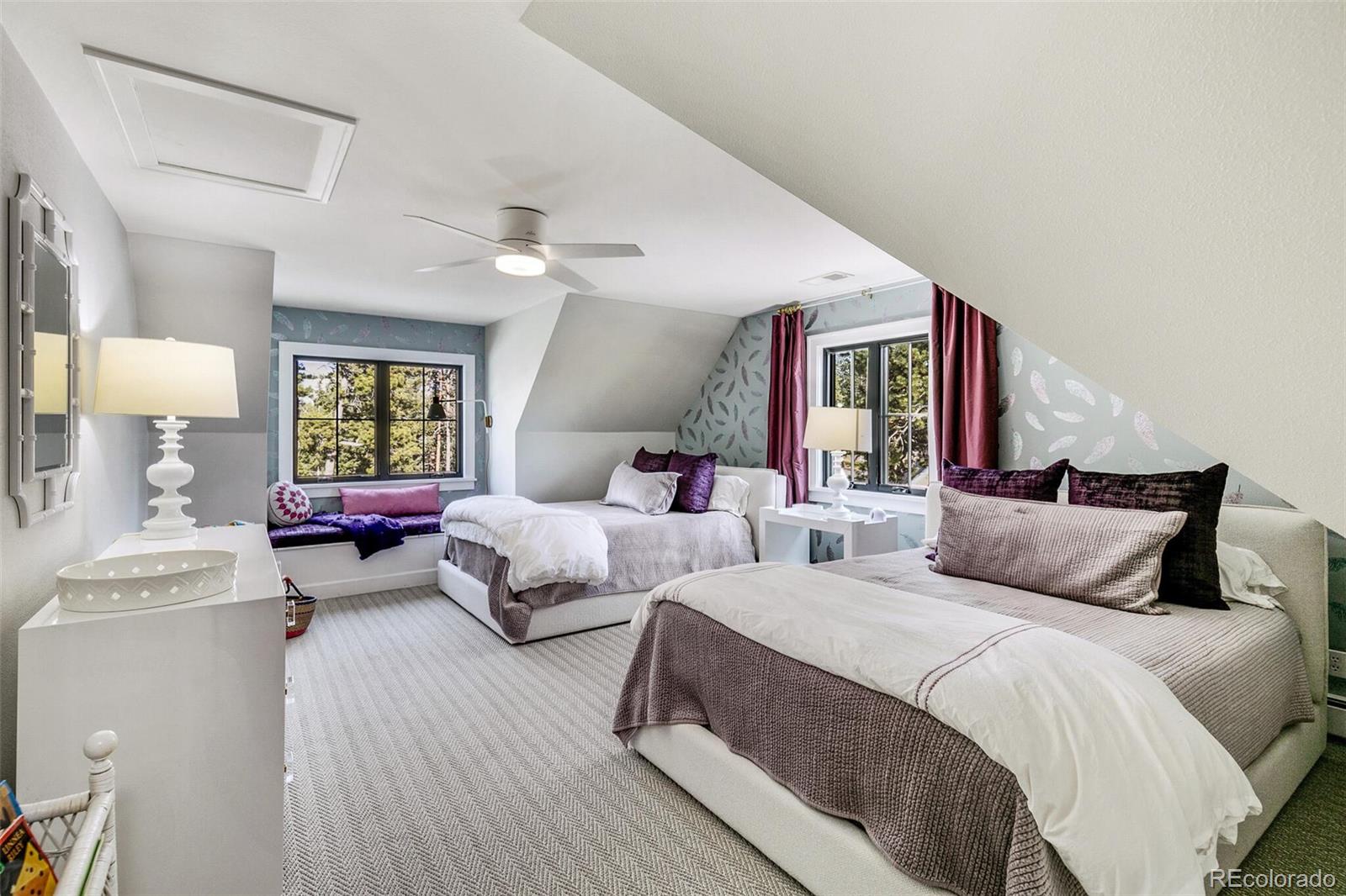 1128 County Road 65 Evergreen, CO 80439 - Photo 23 of 40 a bedroom with two beds and a chandelier