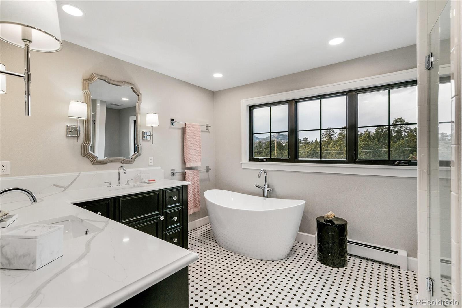 1128 County Road 65 Evergreen, CO 80439 - Photo 24 of 40 a bathroom with a double vanity sink mirror and bathtub