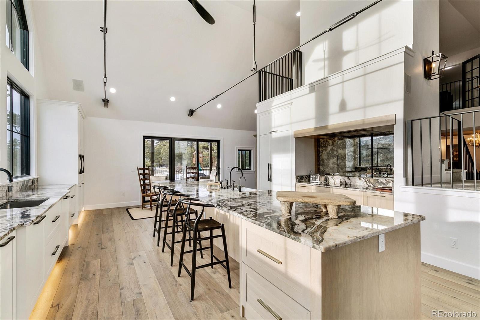 1128 County Road 65 Evergreen, CO 80439 - Photo 3 of 40 a view of a dining room and livingroom with furniture wooden floor a flat screen tv