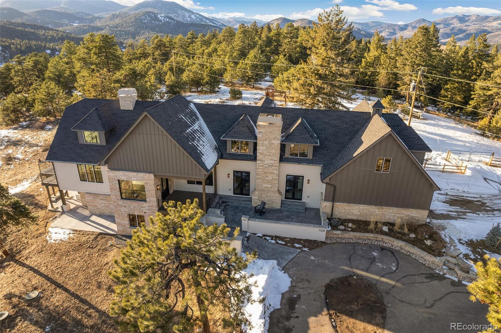 1128 County Road 65 Evergreen, CO 80439 - Photo 32 of 40 an aerial view of a house with a yard lake and mountain view